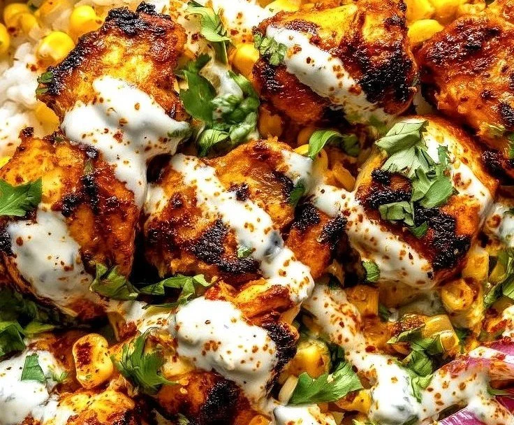 A delicious corn chicken bowl garnished with fresh ingredients