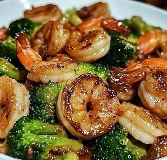 Delicious high-protein honey garlic shrimp served on a plate with herbs
