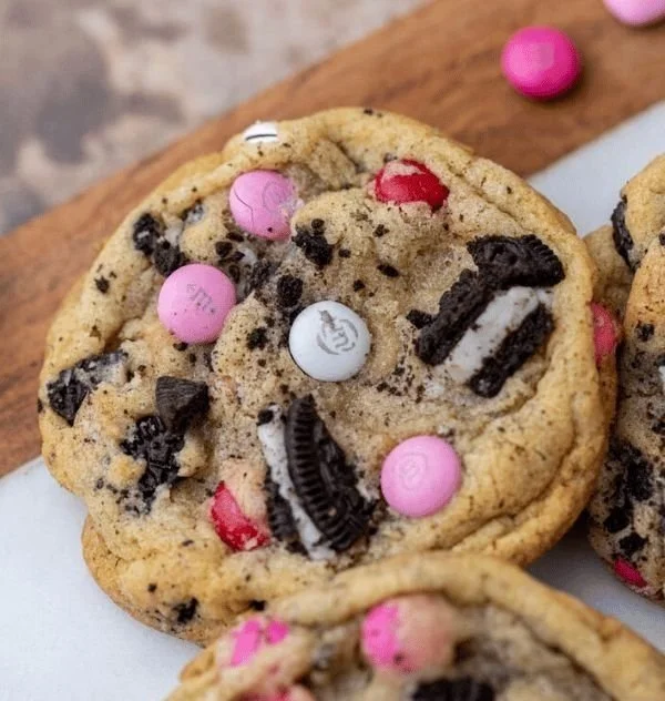 Valentine's Day Oreo M&M's cookies decorated with love-themed sprinkles.