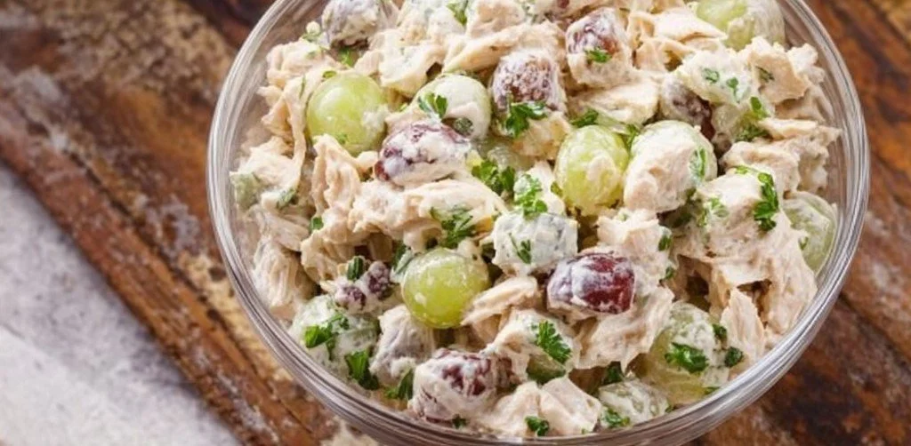 Homemade chicken salad sandwiches on a plate with fresh ingredients