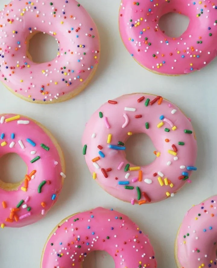Freshly baked vanilla donuts on a cooling rack