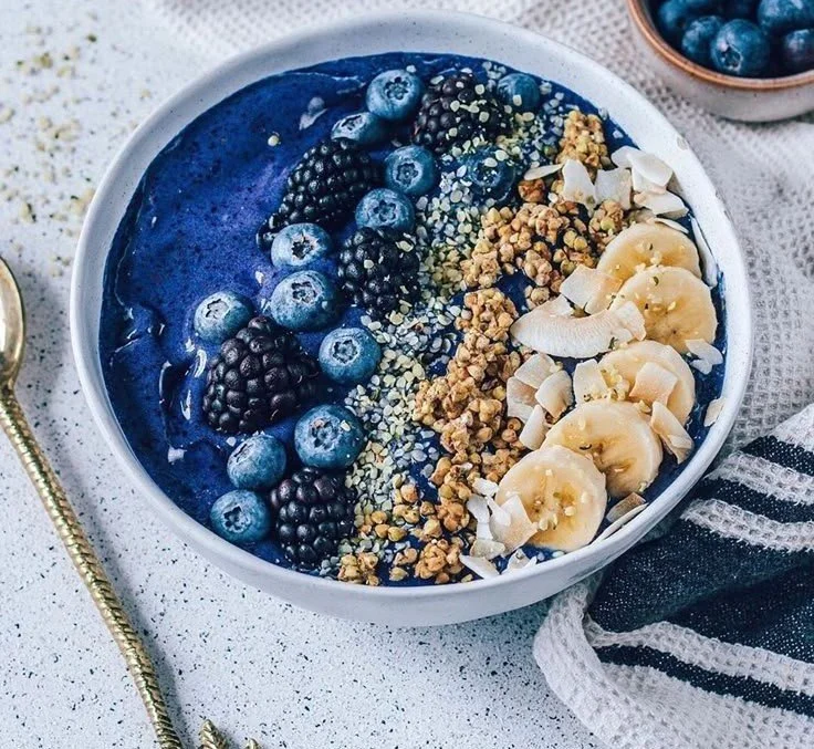 Berry Smoothie Bowl 4 Colorful berry smoothie bowl topped with fresh fruit and granola