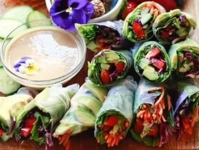 Plate of fresh and delicious spring rolls with colorful vegetables
