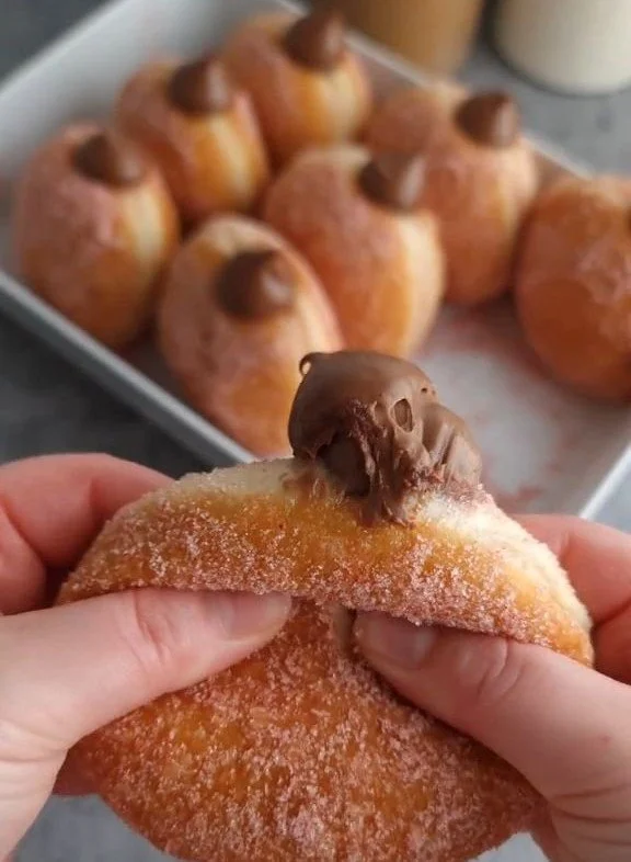 Hazelnut Cream Doughnuts 2 Delicious hazelnut cream doughnuts topped with chocolate glaze and nuts.