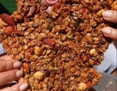 Bowl of healthy homemade granola clusters with nuts and fruits