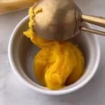 Delicious bowl of Mango Sorbet garnished with fresh mango slices