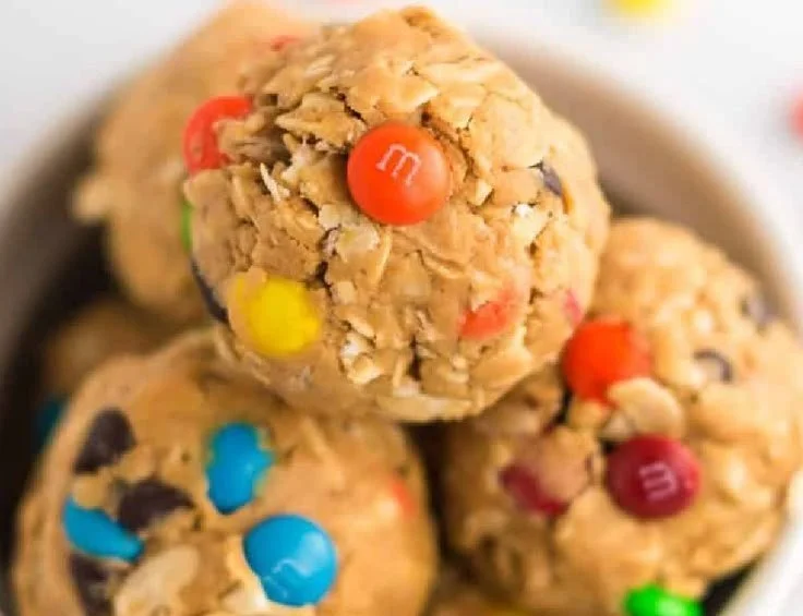 Delicious Monster Cookie Protein Balls stacked on a plate