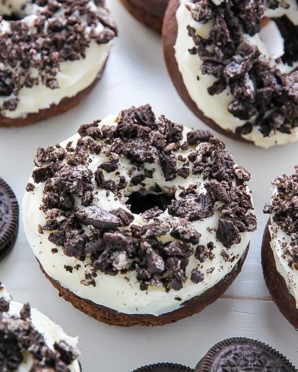 Delicious Oreo cookies and cream donuts with chocolate drizzle and crushed Oreos.