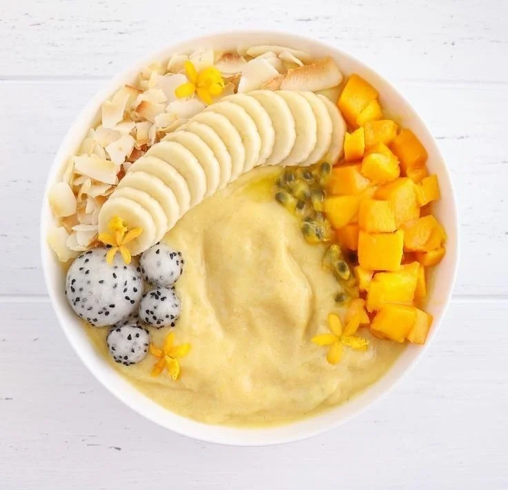 Delicious Passionfruit Mango Smoothie in a glass with tropical fruits