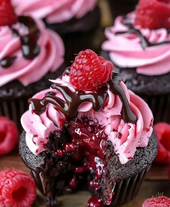 Raspberry Chocolate Lava Cupcakes with molten chocolate filling and fresh raspberries.