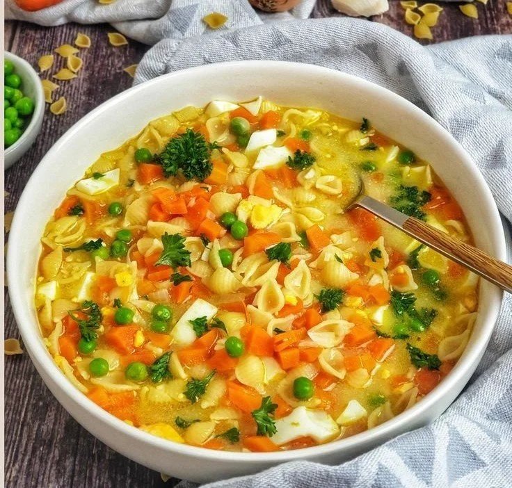 Bowl of Vegetable Noodle Soup with colorful vegetables and noodles