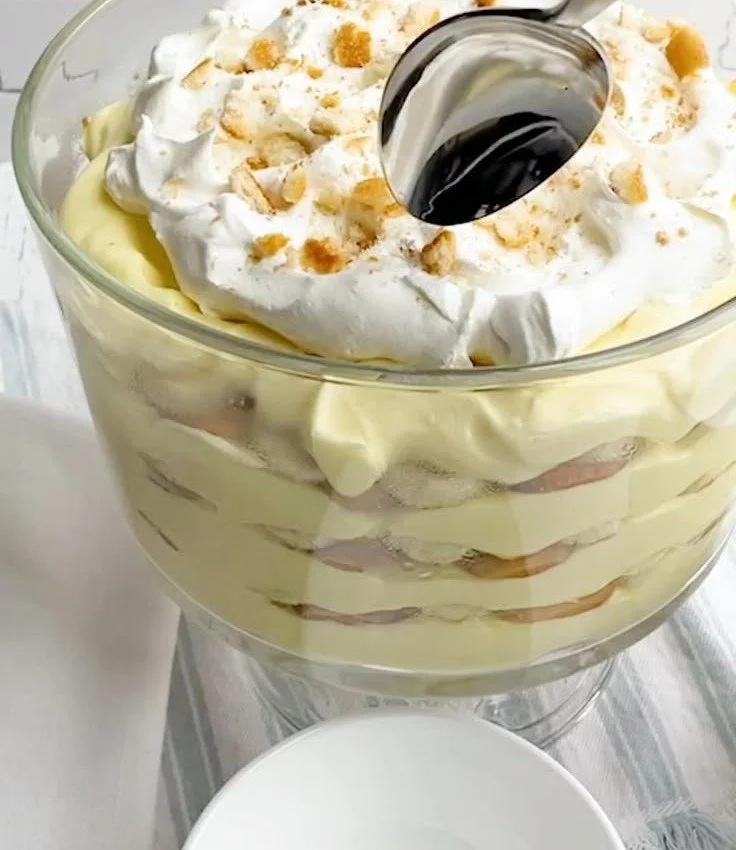 Delicious homemade easy banana pudding in a bowl with whipped cream and bananas.