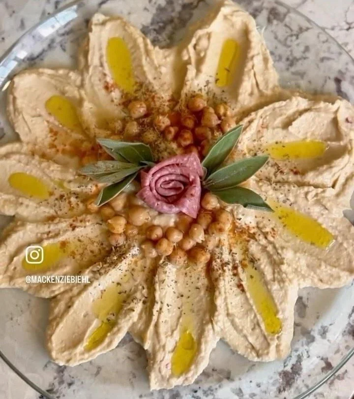 Bowl of homemade hummus with olive oil and paprika