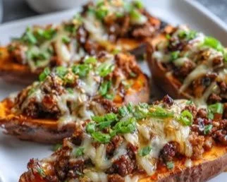 Hot Honey Ground Beef & Sweet Potato Boats topped with honey glaze and herbs
