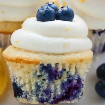 Delicious lemon blueberry cupcakes with frosting on a white plate