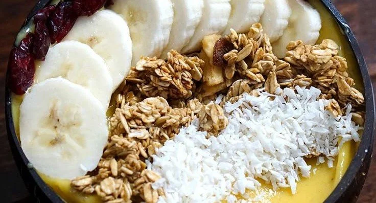 Mango Banana Smoothie Bowl 4 Delicious mango banana smoothie bowl topped with fresh fruits and nuts
