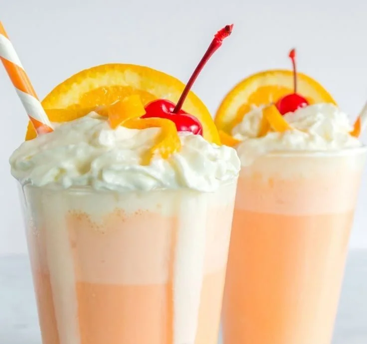 Orange Creamsicle Milkshake 4 Delicious orange creamsicle milkshake topped with whipped cream and orange slices