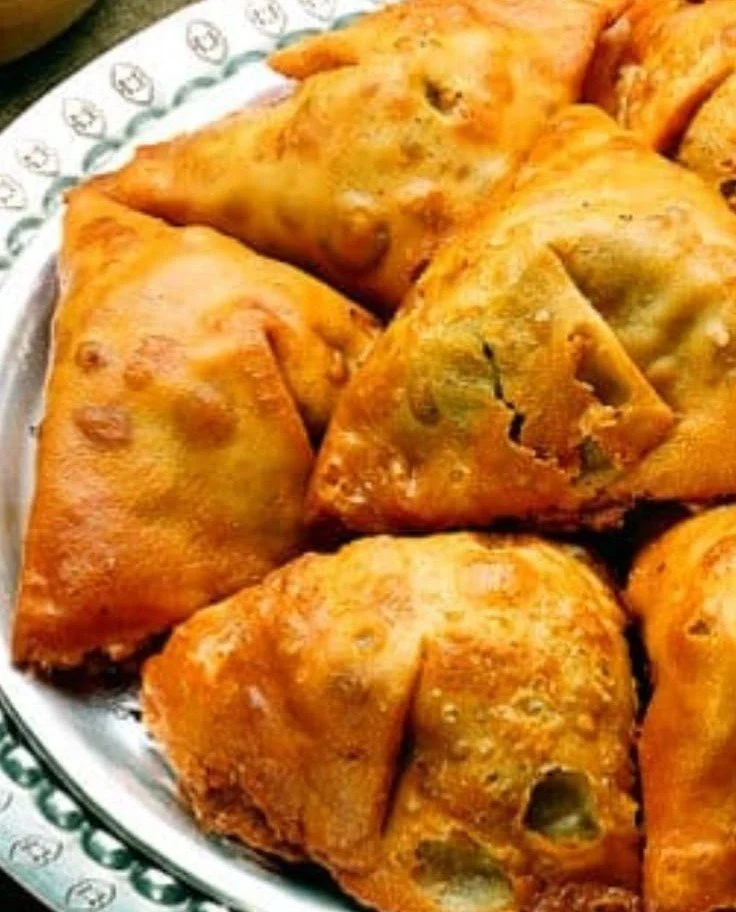 The Irresistible Indian Samosa 4 Delicious Indian samosa filled with spiced potatoes and peas, a popular snack.