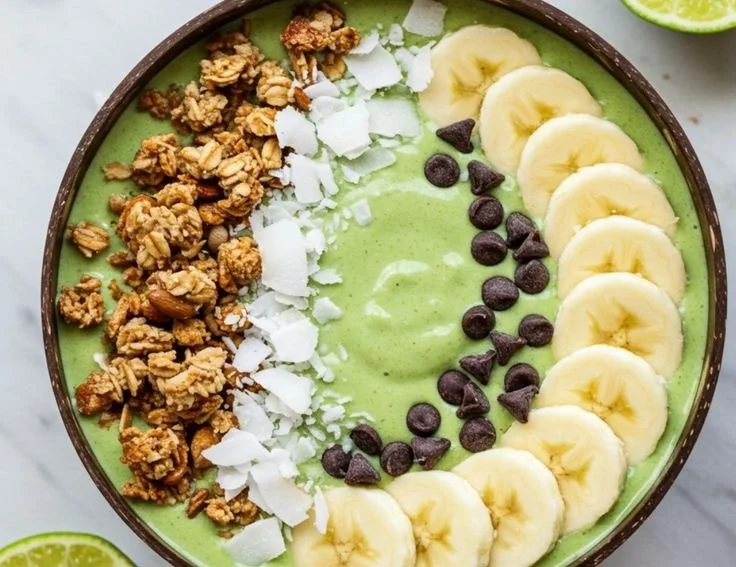 Tropical Lime Coconut Smoothie Bowl topped with fruit and coconut flakes